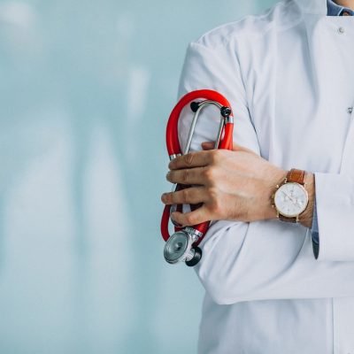 Young handsome physician in a medical robe with stethoscope