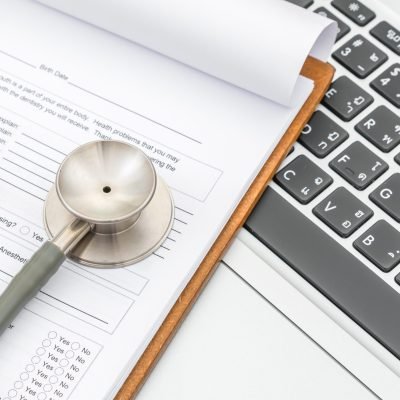Stethoscope and prescription on laptop